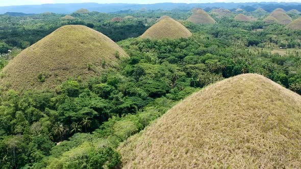 Aerial parallax reveal of chocolate hills. Chocolate Hills viewing complex, Bohol, Philippines