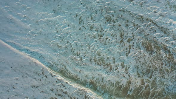 waves and sea foam on the beach