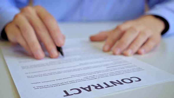 Businessman Signing Business Contract Agreement, Close Up of Male Hand with Pen Writing Signature