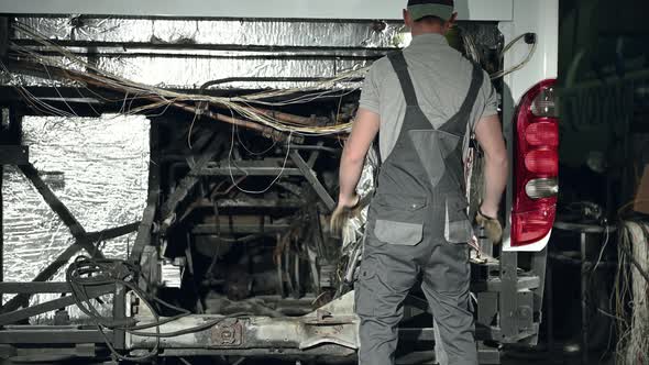 Automotive Worker Attending To Fix Electrical Bus Problems