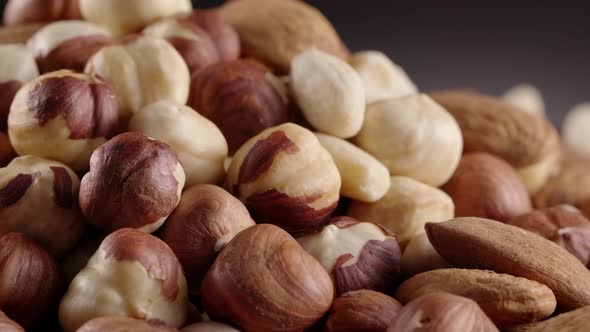 Almond, hazelnut, peanut, cashew turning around in slow motion