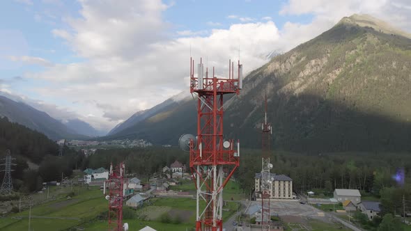 Mobile Telecommunication Tower in the Small Town Between Mountains