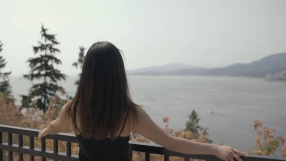 Young Asian girl in great mood enjoying view at Prospect point and looks to the camera, Slowmo