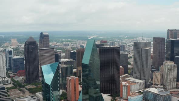 Forwards Flying Drone Towards Modern Tall Buildings at Fountain Place with Glass Facades and