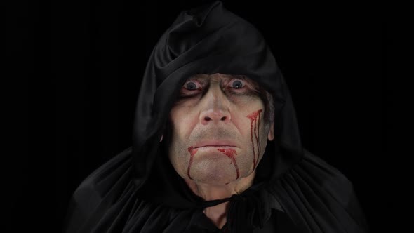 Old Executioner Halloween Makeup and Costume. Elderly Man with Blood on His Face