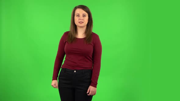 Angry Girl Is Scolding, Shaking Her Index Finger and Threatening with a Fist. Green Screen