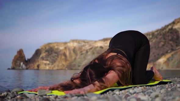 Young Woman with Long Hair Fitness Instructor in Black Sportswear Leggings and Tops Stretching