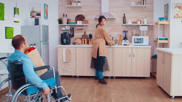 Disabled Man in Wheelchair with Groceries