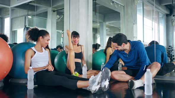 4K Group of man and woman relaxing after do workout exercise together at fitness gym