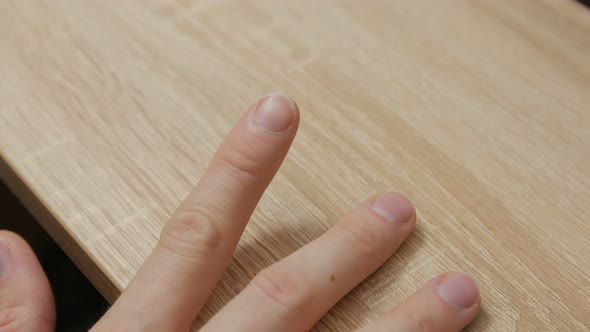 Man Cuts Nails