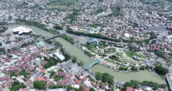 Aerial view of Tbilisi city central park and Bridge of Peace. Beautiful cityscape of old Tbilisi at