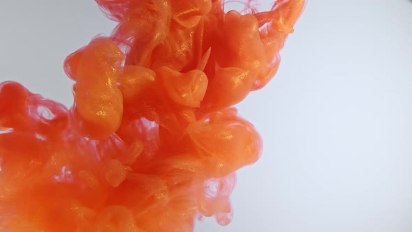 Colorful Nacreous Paint in Water Against White Background alt