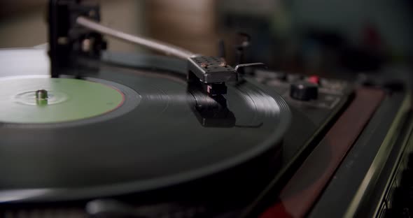 Hand Turns on a Vintage Vinyl Record and Vinyl Record is Spinning