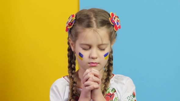 War in Ukraine. Ukrainian Child against war. Praying child Gunning of civilians.