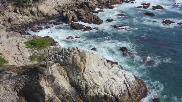 Aerial Pan Around of Waves Crashing on the Rocky Shores of Big Sur California