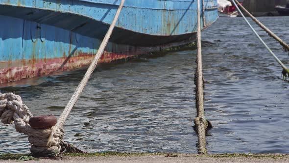 Rusty Mooring Bollard With Old Ship Ropes 