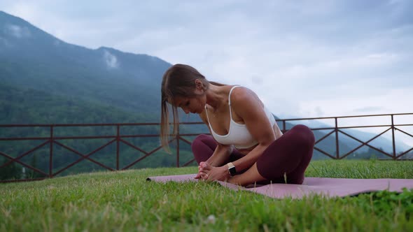 Woman Doing Stretching Exercises View Against Mountains