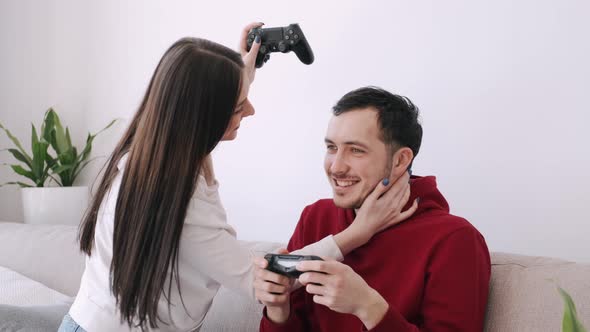 A Pretty Girl and a Boy Are Playing Video Games in the Living Room