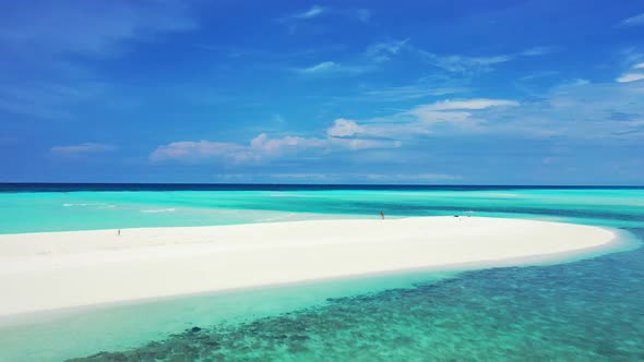 Wide angle birds eye copy space shot of a sunshine white sandy paradise beach and blue water backgro