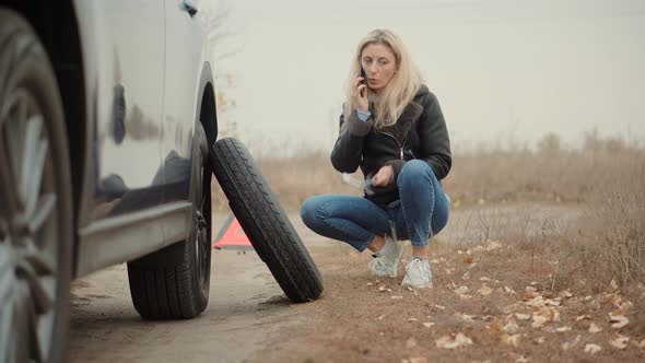 Flat Tire. Flat Tyre Car Accident. Woman Repair Tire.Woman Calling To Car Insurance Company.