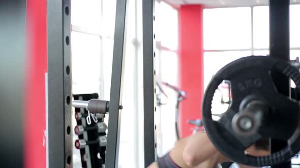 Motivated Sportswoman Squatting With Heavy Barbell on Shoulders, Active Workout