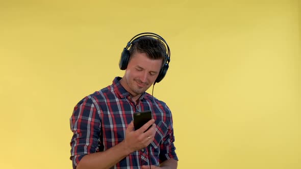 Handsome Man in Headphones Enjoying Listening to the Music