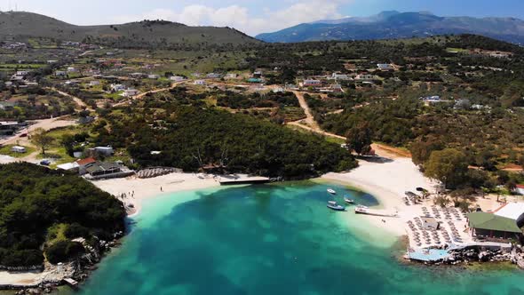 Aerial View of a White Sandy Beach with Many Sun Loungers Without People on a Sunny Day on the