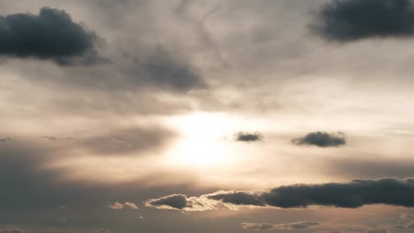 Clouds in the Sky Move Against the Background of the Sun at Sunset Timelapse