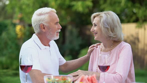 Seniors Sitting at Table and Remembering Their Life Together, Happy Marriage