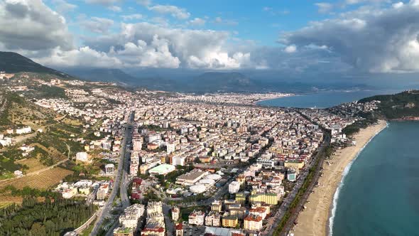 Aerial drone view of parachute jumper flying over beautiful Alanya