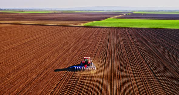 Tractor with seed drill on plowed field