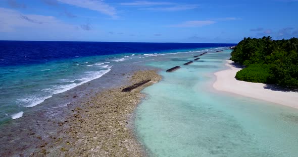 Beautiful drone island view of a sandy white paradise beach and blue sea background in high resoluti