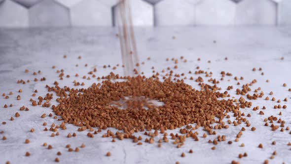 Buckwheat is Pouring on Gray Concrete Background