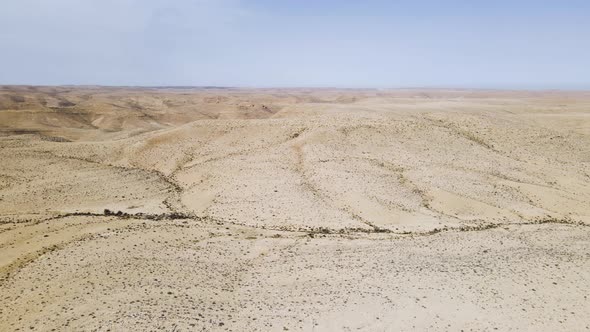 Endless hills and mountains of Negev Desert, Israel - aerial side panning