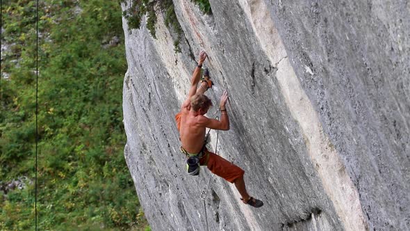 A man rock climbing up a mountain.