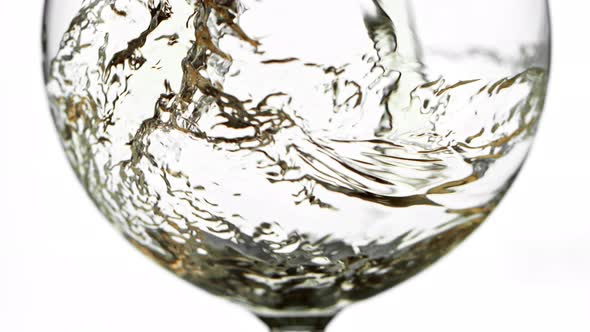 Super Slow Motion Detail Shot of Pouring White Wine Isolated on White Background at 1000Fps