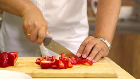 Close Up Man Cuts Fresh Red Pepper Into Slices Cooking Vegan Healthy Side Dish