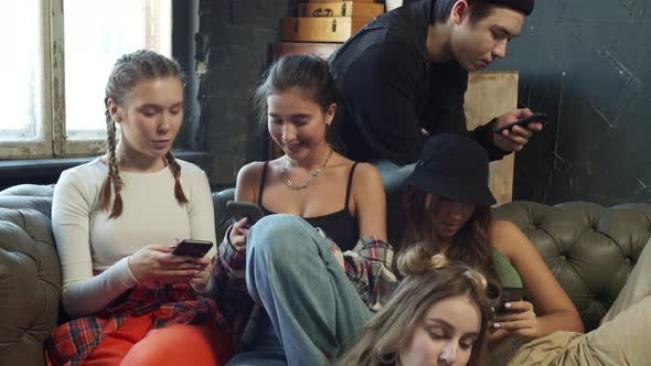 Stylish Children of Same Age Stuck in the Smart Phones Sitting Together