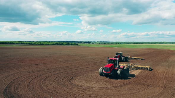 Two Tractors Plough a Big Field, Preparing for Sow