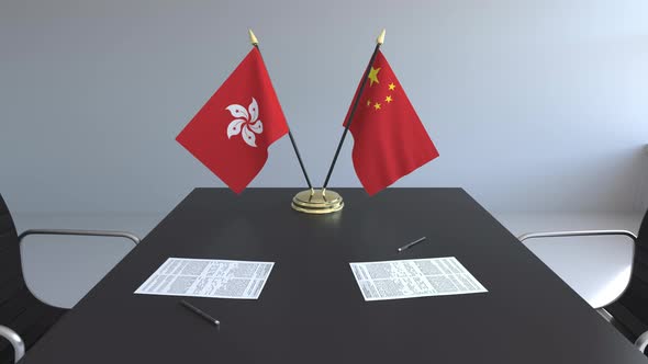 Flags of Hong Kong and China and Papers on the Table alt