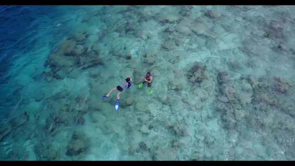 Young couple happy together on luxury coast beach journey by aqua blue sea with bright sand backgrou