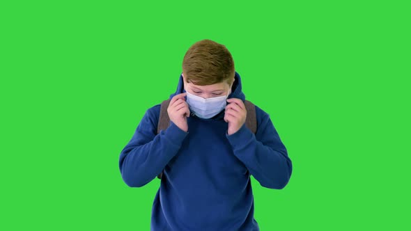 Teenager Boy Walking in Medical Mask To School on a Green Screen, Chroma Key.