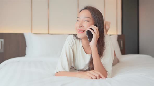 Young asian woman use smart phone in room