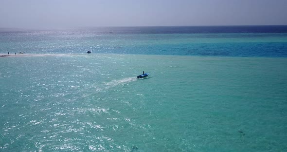 Daytime fly over abstract shot of a paradise sunny white sand beach and blue ocean background in vib