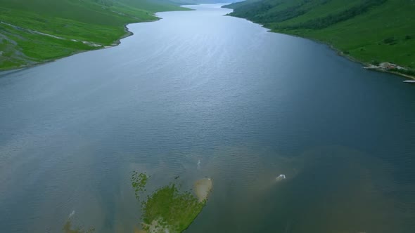 Drone shot reveals Glen Etive in between mountain peaks