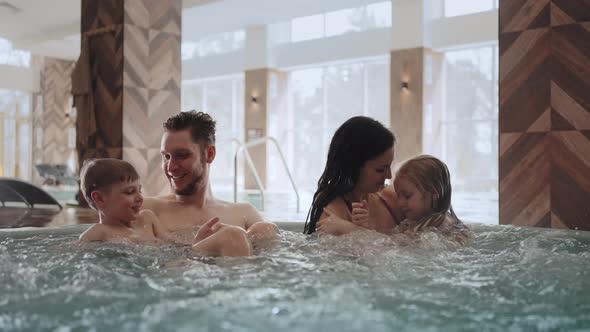 Modern Balneological Center with Thermal Water Happy Family with Children is Relaxing in Jacuzzi