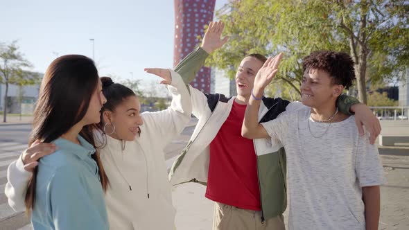 Group of Young People Having Fun Together and Stacking Hands Outdoors