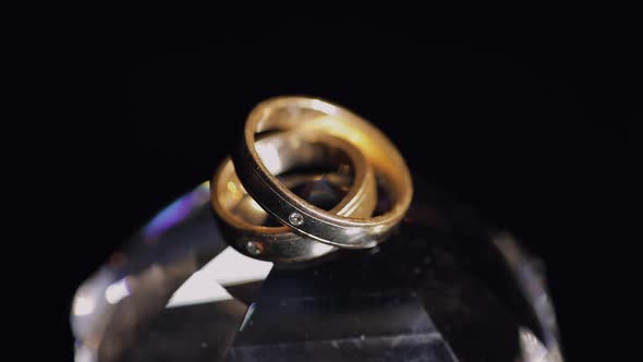 Wedding Rings Lying on Crystal Shining with Light Close Up Macro