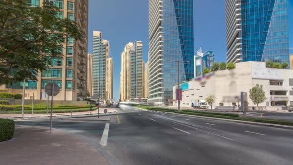 Dubai Marina with Skyscrapers Timelapse Hyperlapse and Traffic on the Street Near Concrete Road