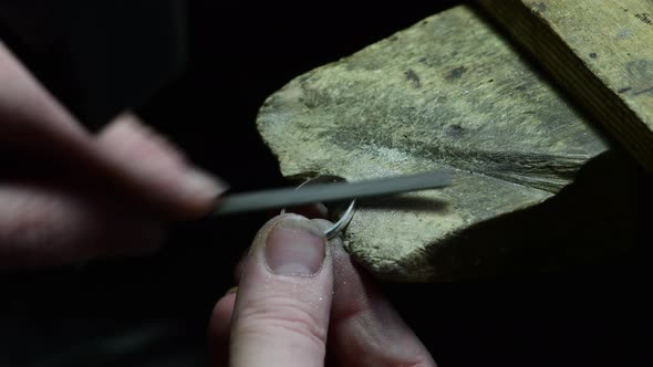 Closeup of Wedding Ring Crafting By Caicasian Jeweler in Home Workroom  High Quality Footage